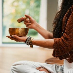 woman in brown knit woman in brown knit sweater holding brown ceramic cup
